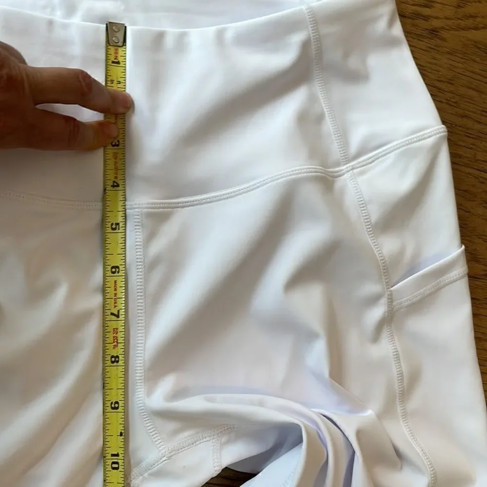 Kcutteyg white exercise capris with side pockets.  New with tags